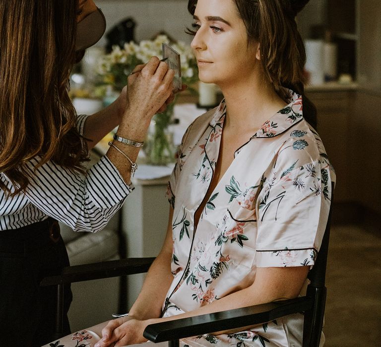 Wedding morning bridal preparations with the bride in satin pink floral pyjamas 