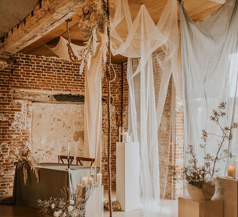 Bohemian luxe wedding inspiration at Godwick Great Hall and Barn with drapes, white flowers and natural wedding decor 