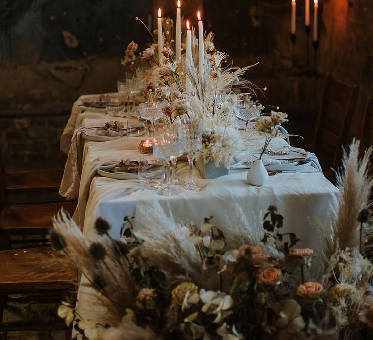 Cream and beige dried flower and candle wedding table centrepieces at The Asylum wedding venue 