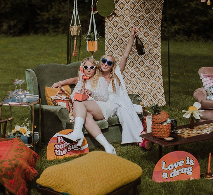 Outdoor seating area for Sixties wedding with retro prints, vintage furniture and cushions in bold colours