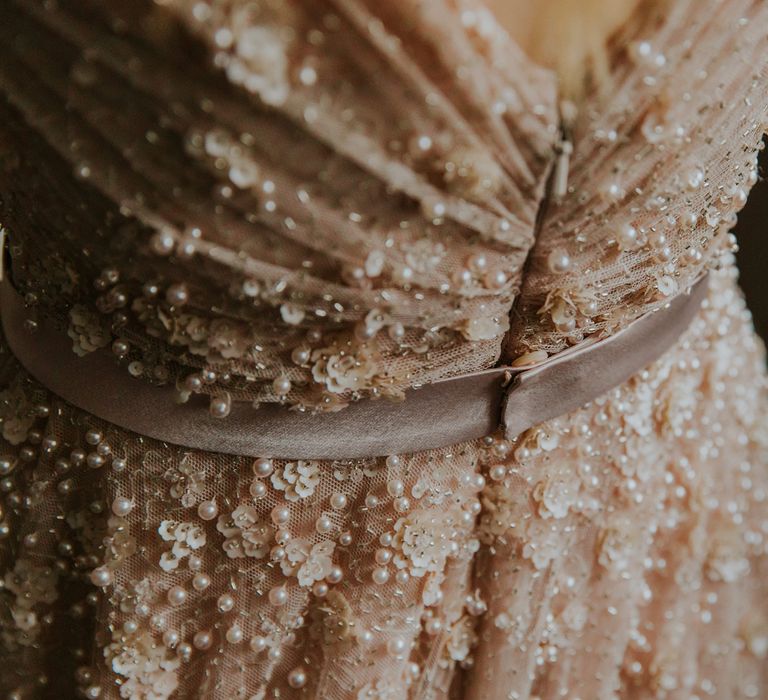 Back of pearl wedding dress with sequins and tulle before barn wedding ceremony