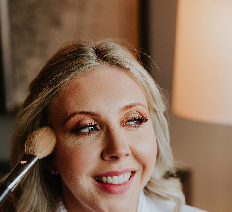 Bridal makeup with brown eyeshadow, false eyelashes and pink lipstick 