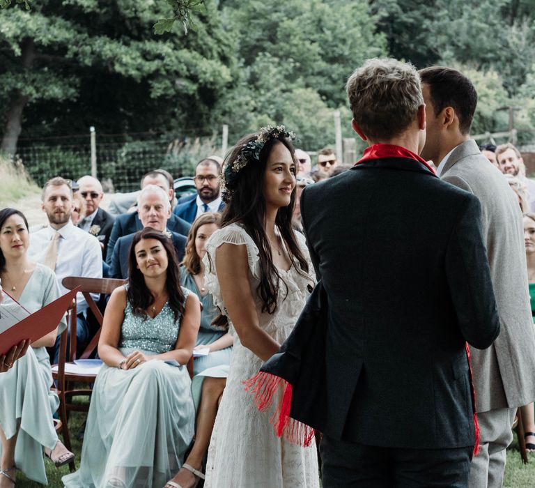 Bride & groom during outdoor wedding ceremony