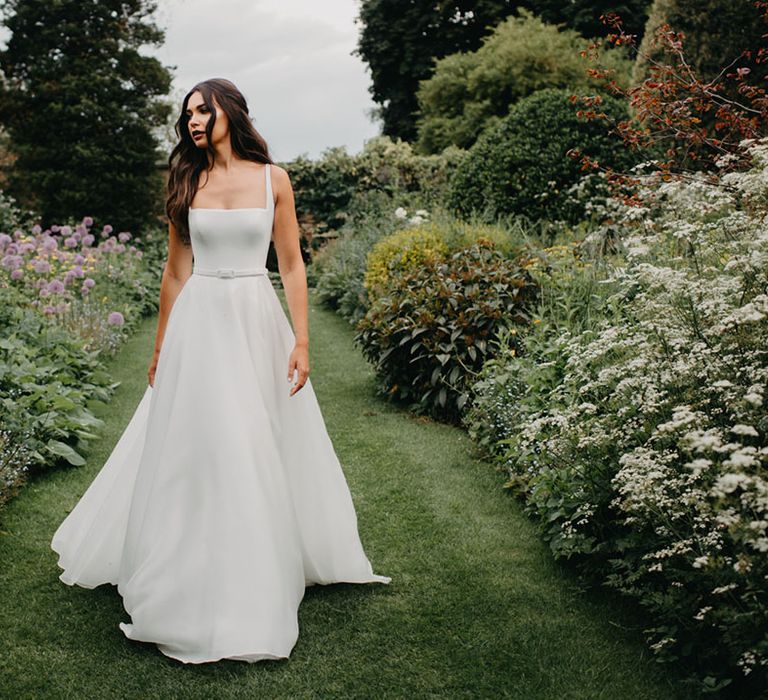 Elegant Suzanne Neville bridal gown with full skirt, fitted bodice and thin straps 