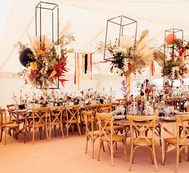 Hanging dried flower installations for wedding in marquee