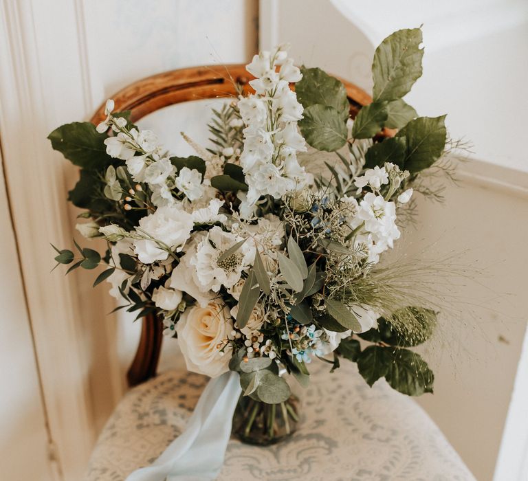 Beautiful white mixed floral bouquet with foliage for bride