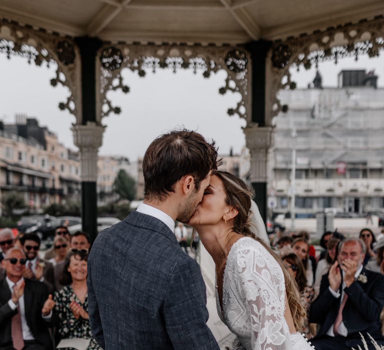 Bride and groom kiss at Brighton bandstand wedding