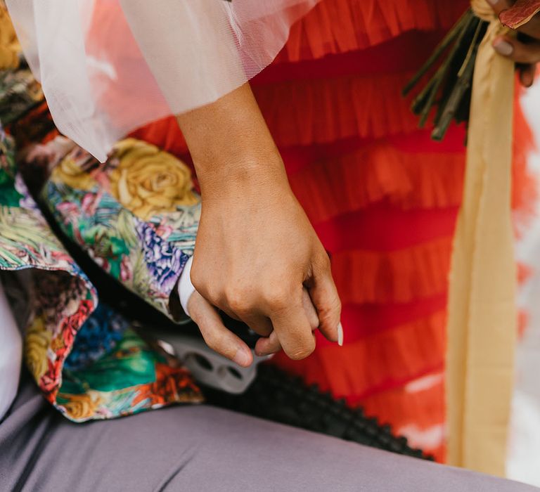 Interabled couple holding hands at their Shoreditch elopement 