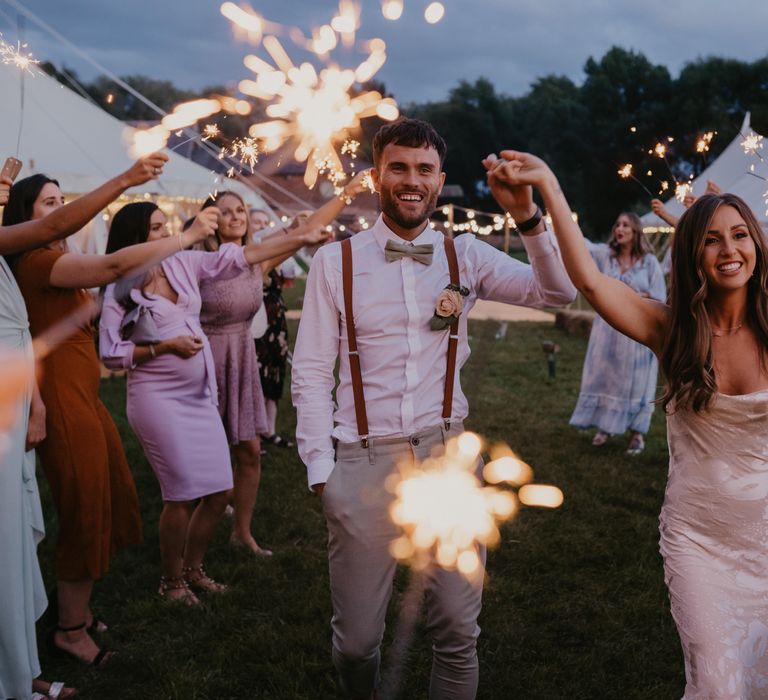 Bride & groom walk through sparklers held by wedding guests on their wedding day | Mark Bamforth Photography