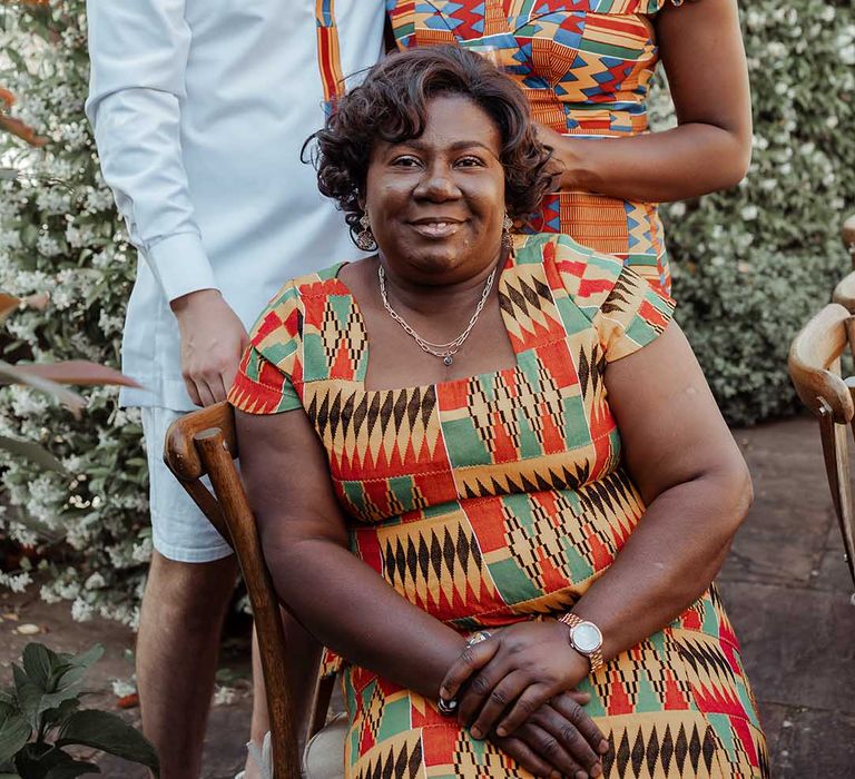 Bride & groom sit with mother of the bride 