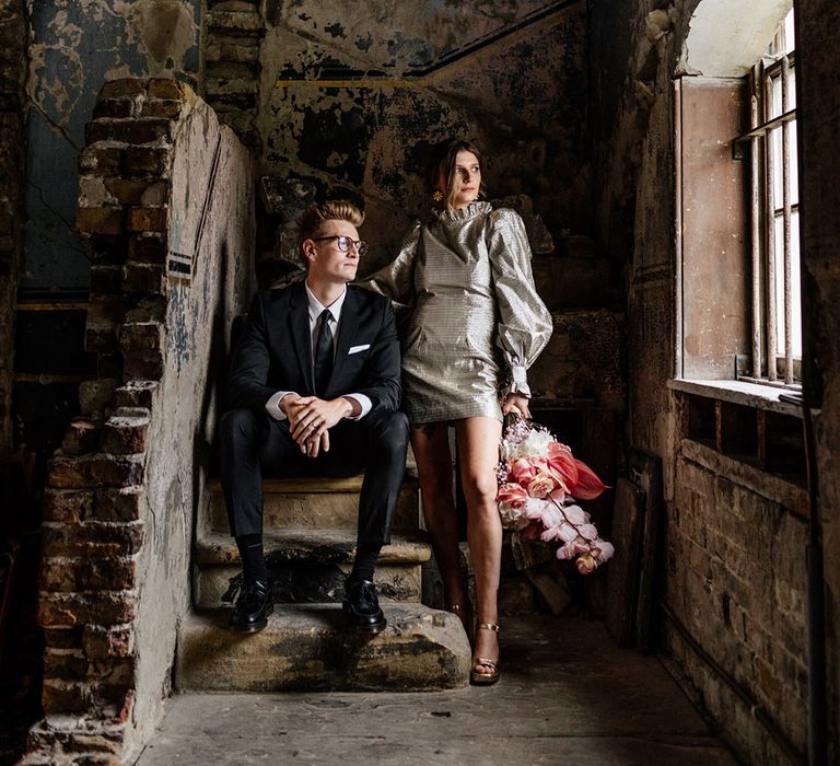 Bride and Groom in asylum chapel in London surrounded by stone brick in The Asylum London