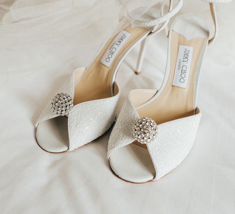 White sparkle peep toe Jimmy Choo wedding shoes with single strap and Halfpenny London veil