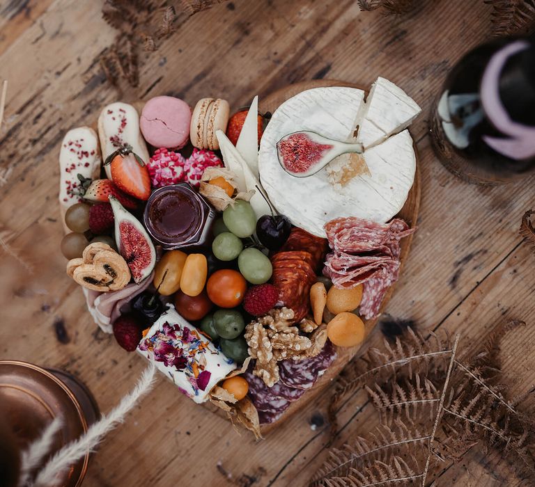 Heart shaped grazing board with cheese and fruits 