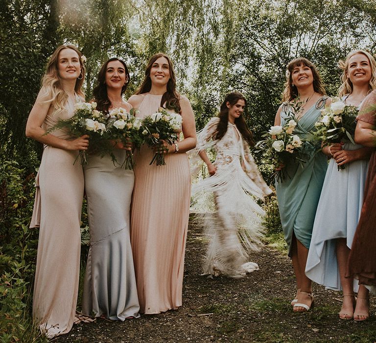 Bride stands with her bridesmaids