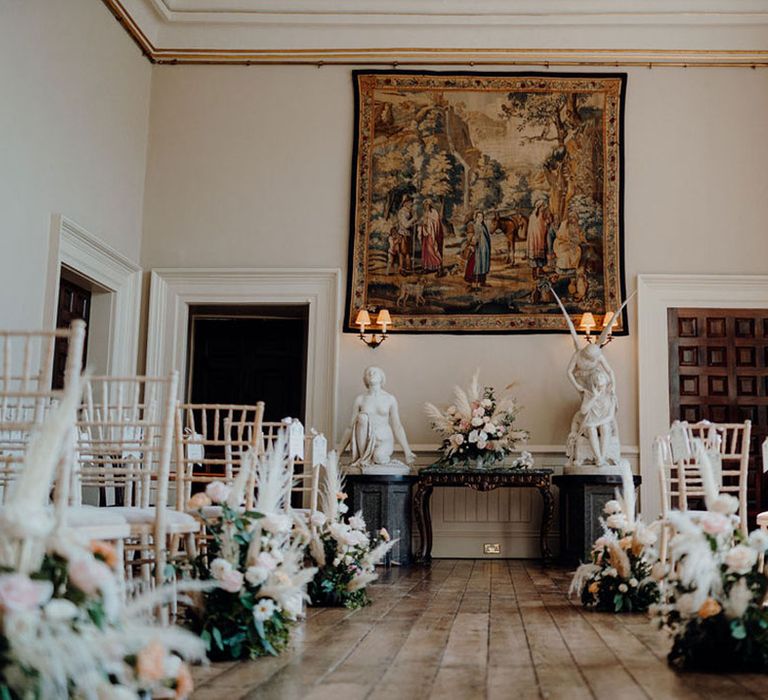 Wedding ceremony room at Elmore Court with dried and fresh flower arrangements lining the aisle