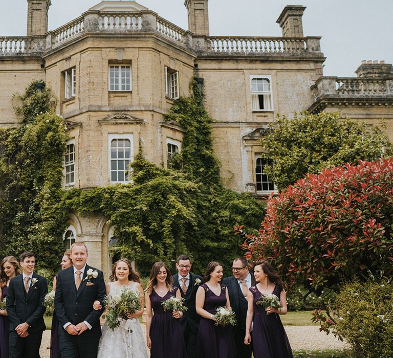 Wedding party stand together in front of Pylewell Park country house wedding venue