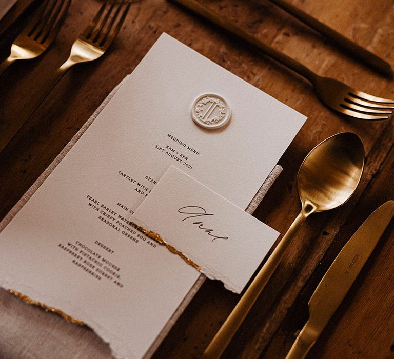 Wedding menu card with ripped edge with gold edges and wax seal with gold cutlery