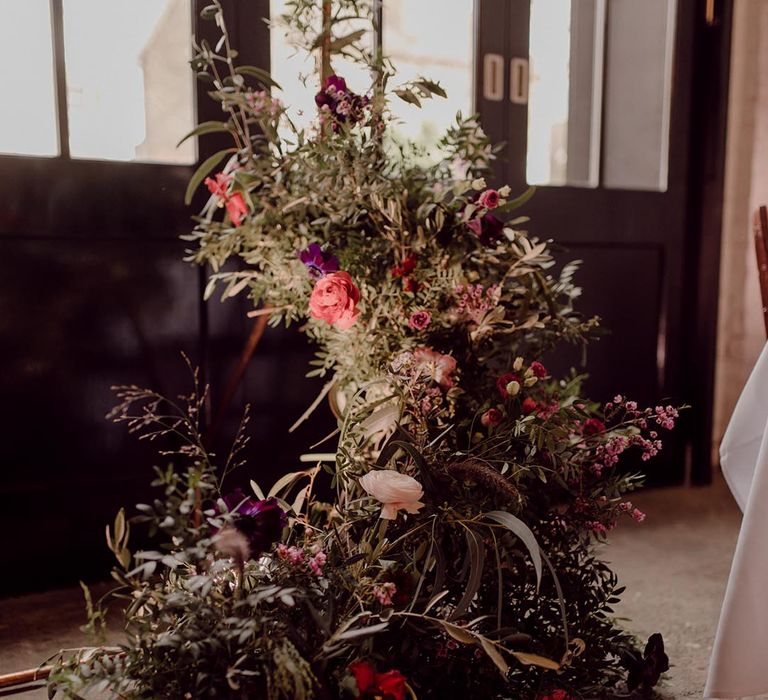 Pink, purple, red and white wedding flower display for wedding at 100 Barrington industrial wedding venue 