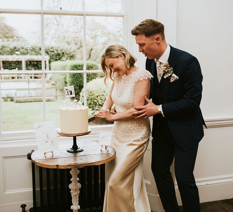 Bride & groom cut wedding cake at Aswarby Rectory 