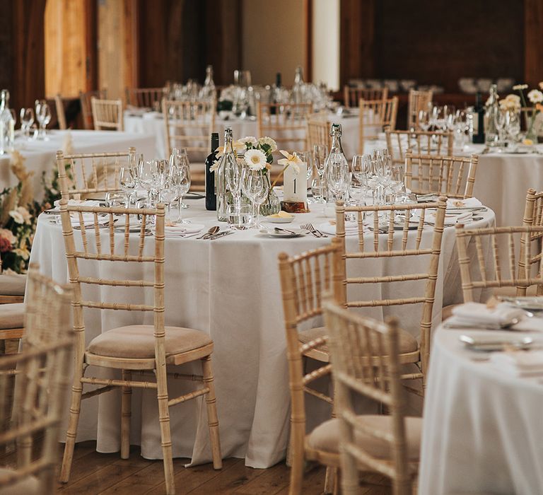 Simple and minimal table settings with small flower arrangements 