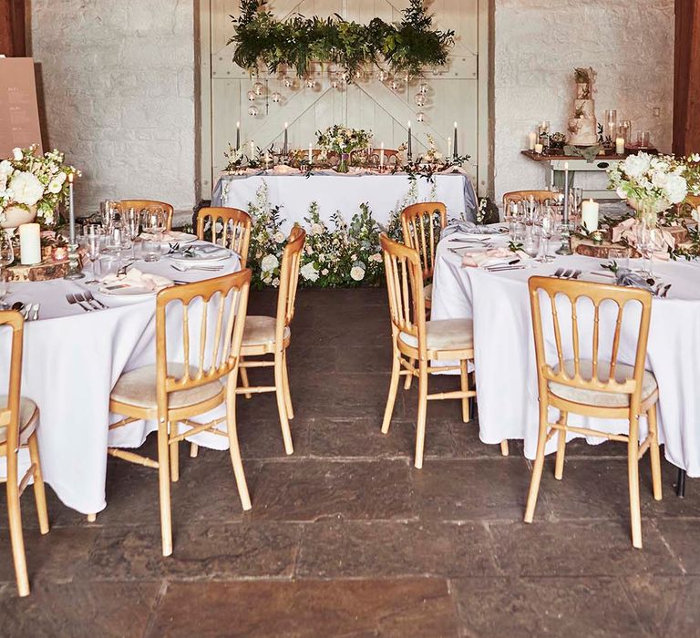 East Riddlesden Hall wedding reception with sweetheart table , hanging foliage and votives and rustic decor 