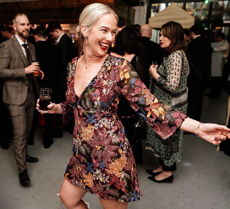 Bride dances in brightly coloured embellished short reception dress from Anthropologie 