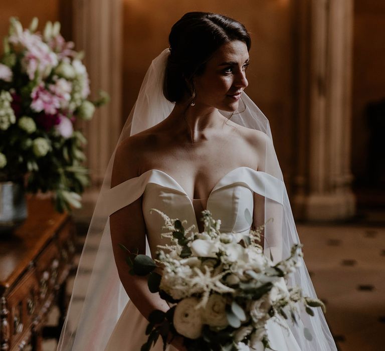 Bride in an off the shoulder wedding dress for elegant and classic wedding 