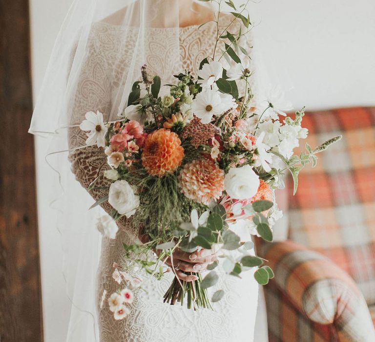 White and orange wedding bouquet with cosmos and dahlias 