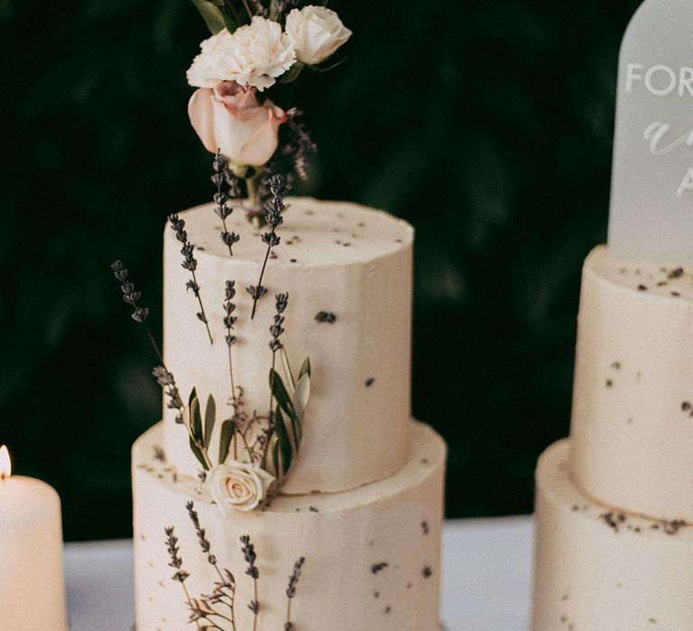 Two tier buttercream wedding cake with dried lavender and white rose decorations 