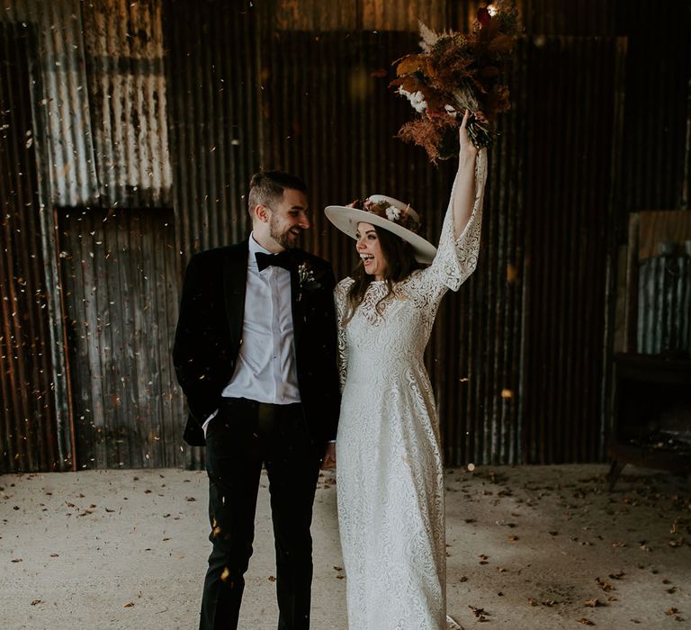 Bride and groom celebrate together on their wedding day at Silchester Farm wedding venue 