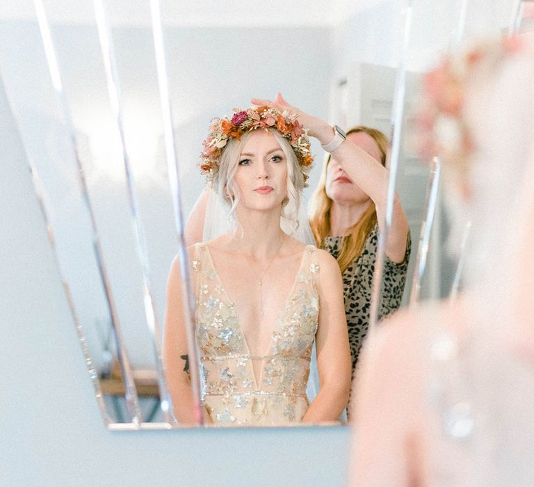 Bride wears sequin embellished wedding dress with Autumnal coloured flower crown in her blonde hair 