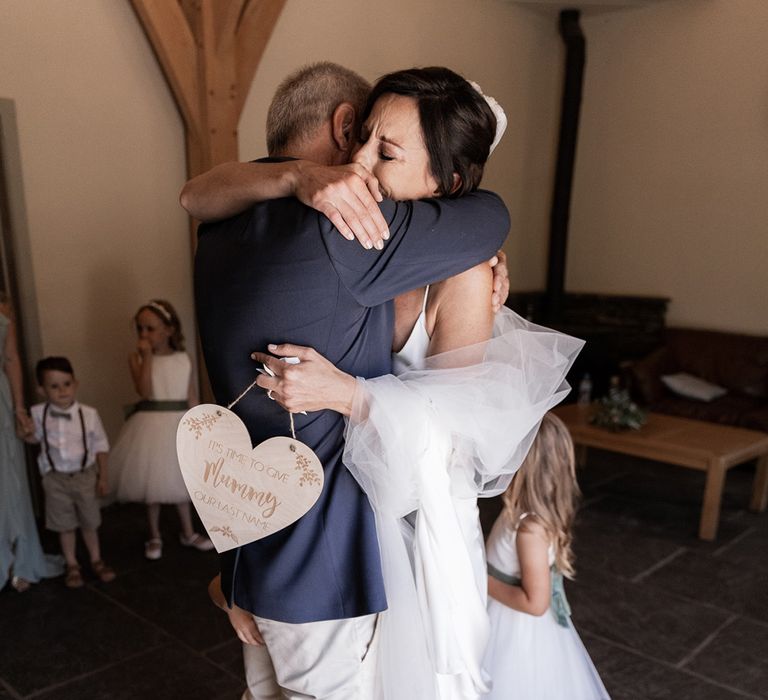 Chloe Bruce bride hugs her father on the morning of her wedding day during first look moment 