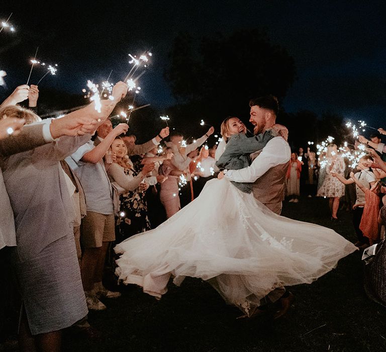 Bride twirls around beside her groom during sparkler exit at The Apple Orchard