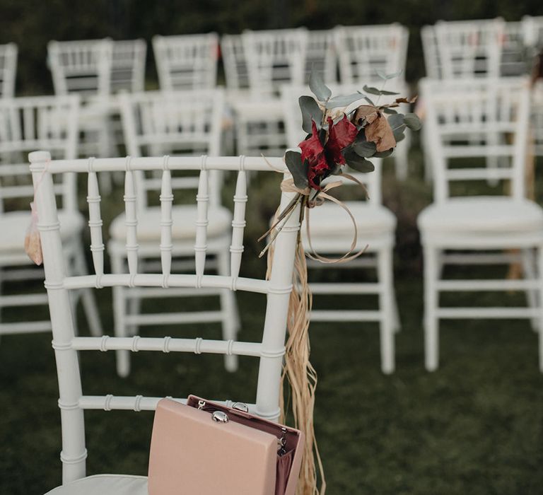 flower wedding chair decor at outdoor wedding ceremony 