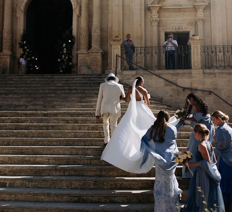 Church bridal entrance with blue bridesmaid dresses