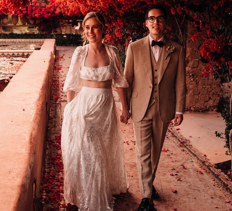 Gorgeous couple portrait of Marrakech wedding with the bride in a long sleeve and maxi skirt bridal separates with the groom in cream suit 