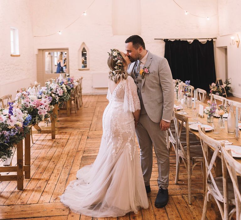 Boho wedding with the bride and groom wearing boho wedding outfits and a wildflower wedding crown for the bride 