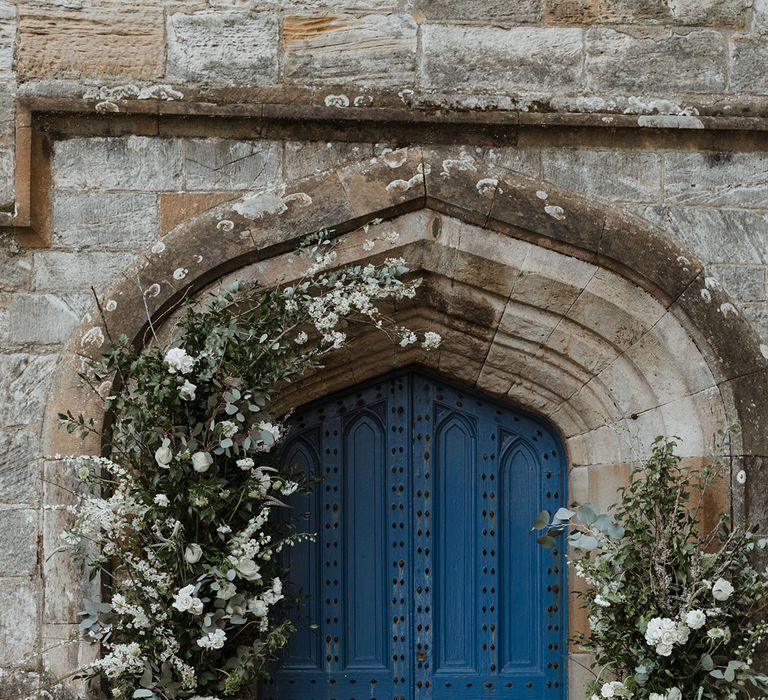 White wedding flower column arrangements for the church entrance decoration 