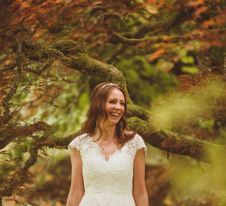 The bride wears a lace cap sleeve wedding dress for traditional Surrey wedding 