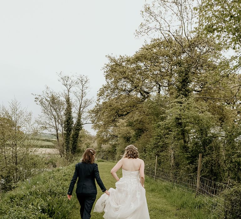 two brides in a navy suit and lace wedding dress at Stanford Farm wedding 