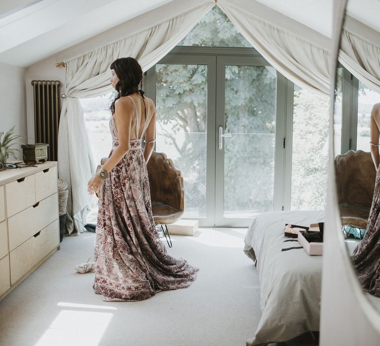 Bride getting ready in low back boho Rue De Seine pink wedding dress