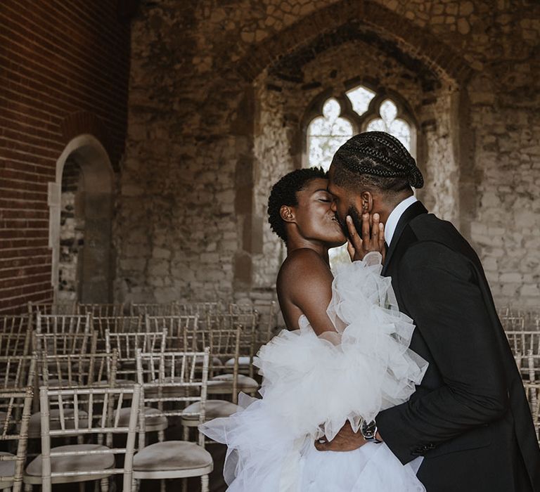 The bride and groom share a passionate kiss as they are announced as husband and wife 