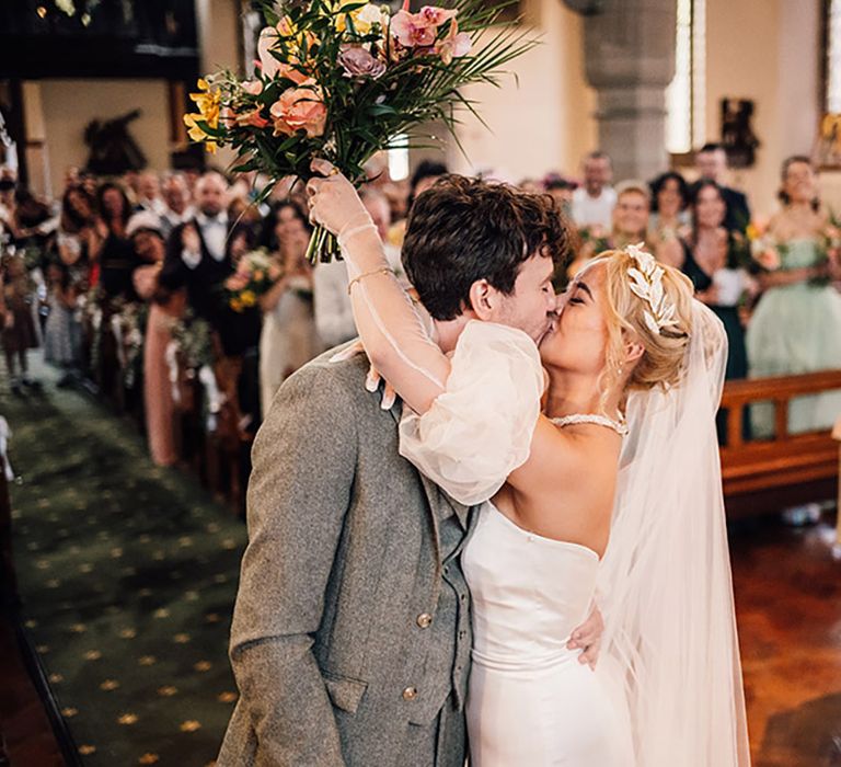 The happy couple share their first kiss as they are announced as husband and wife 