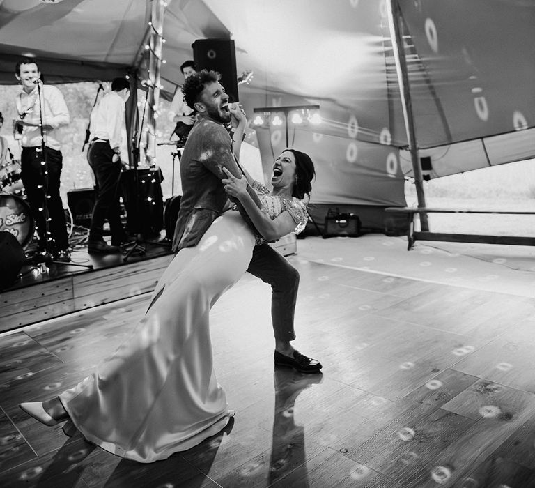 Epic first dance for bride and groom under disco ball and lighting 