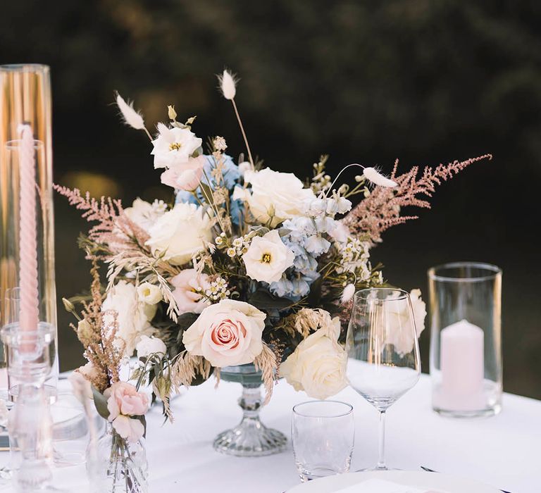 Pink roses, wax flower and bunny grass in pastel boho flower table centrepieces 