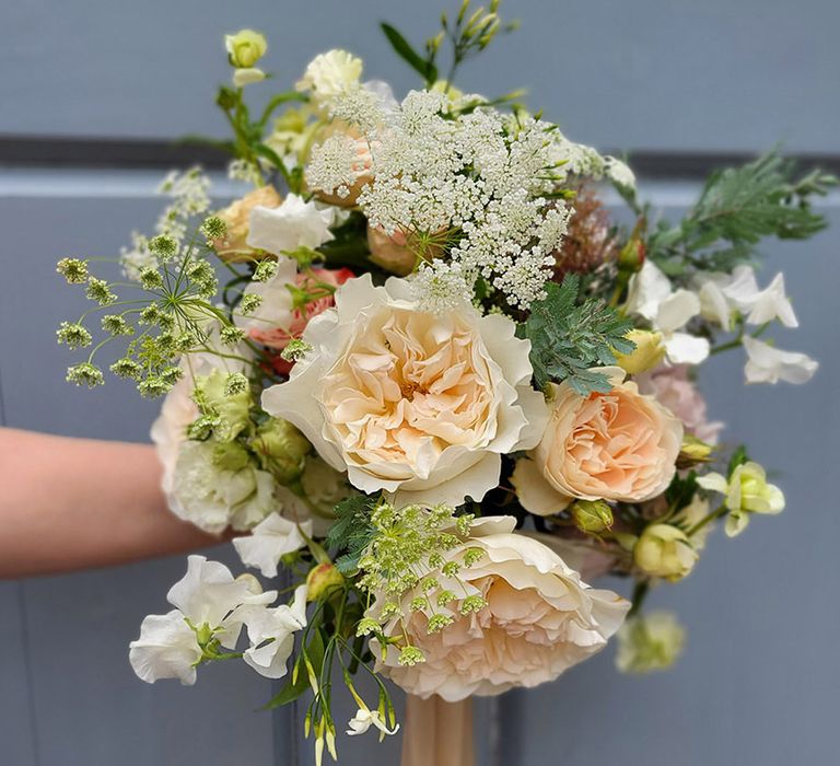 Peach tone wedding bouquet with peonies, Queen Anne's lace and sweet peas 