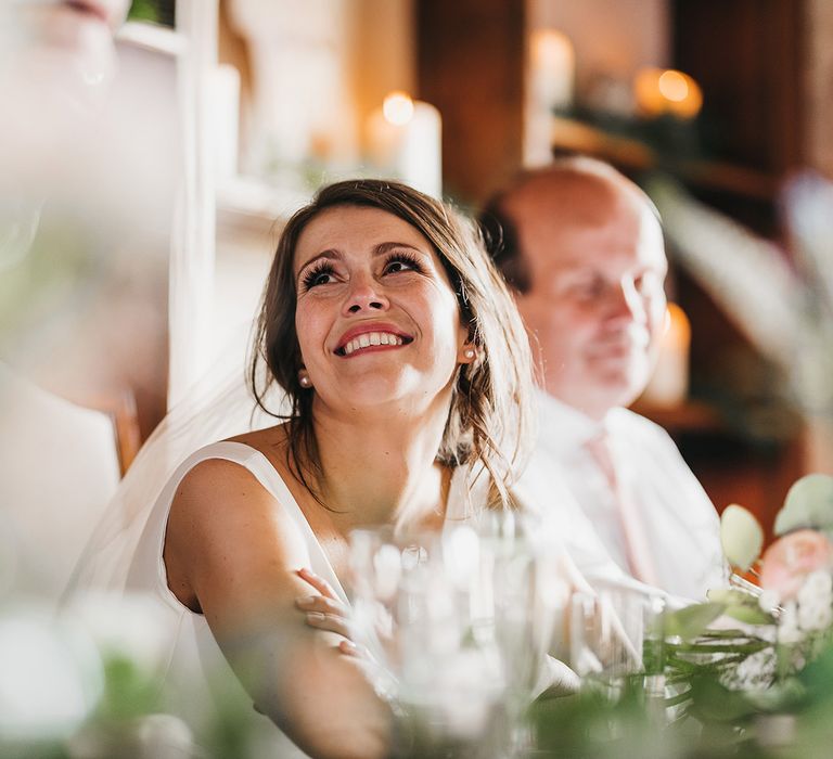 Bride enjoys wedding speeches