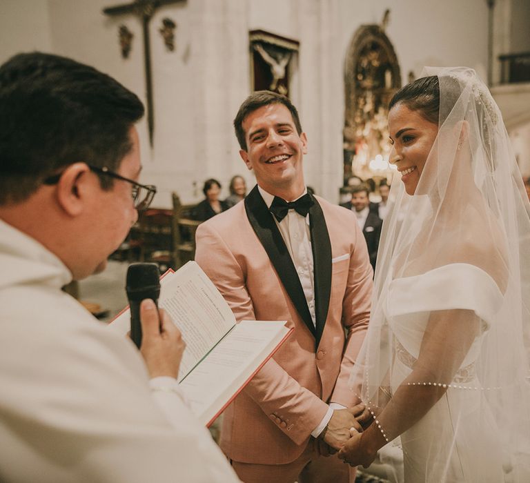 Bride in off the shoulder wedding dress and pearl edged veil