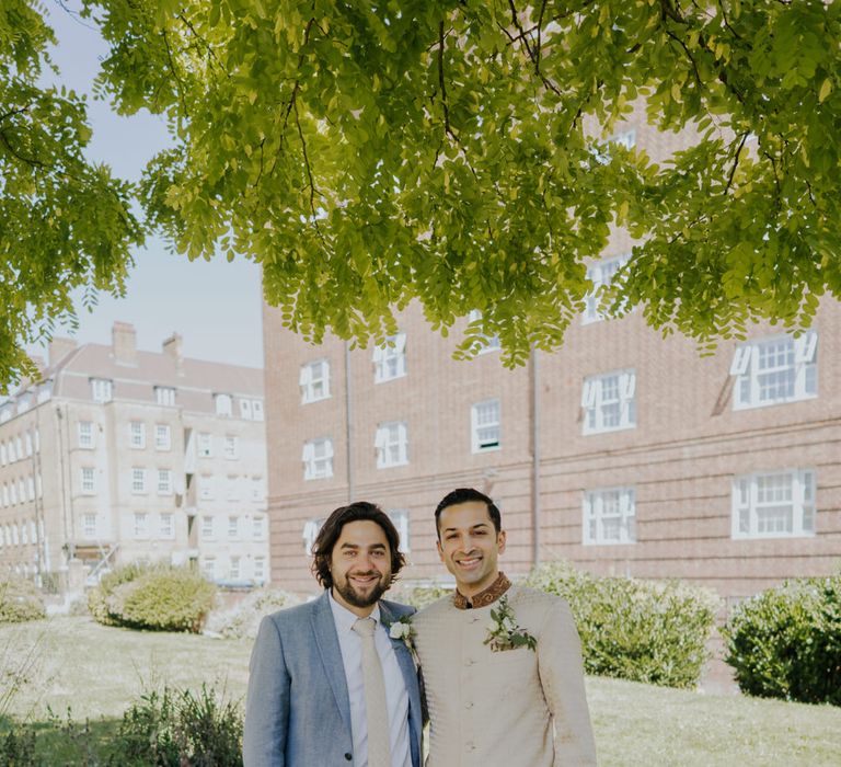 Groom in bespoke suit and best man 