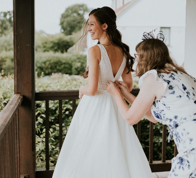 Bride in lace back wedding dress on wedding morning 